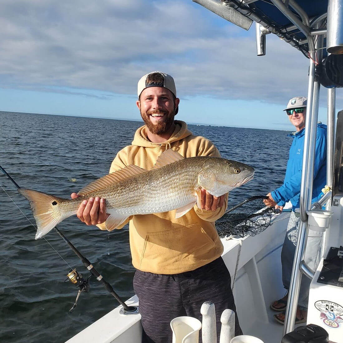 Angler holds up nice red drum.