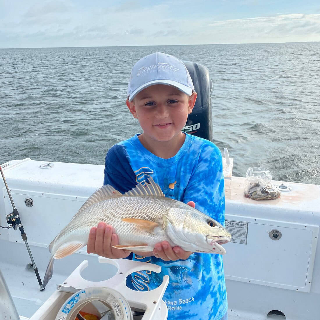 Young angler catches beautifully colored red drum.