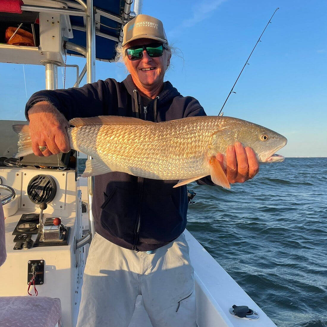 Angler holds up nice red drum.