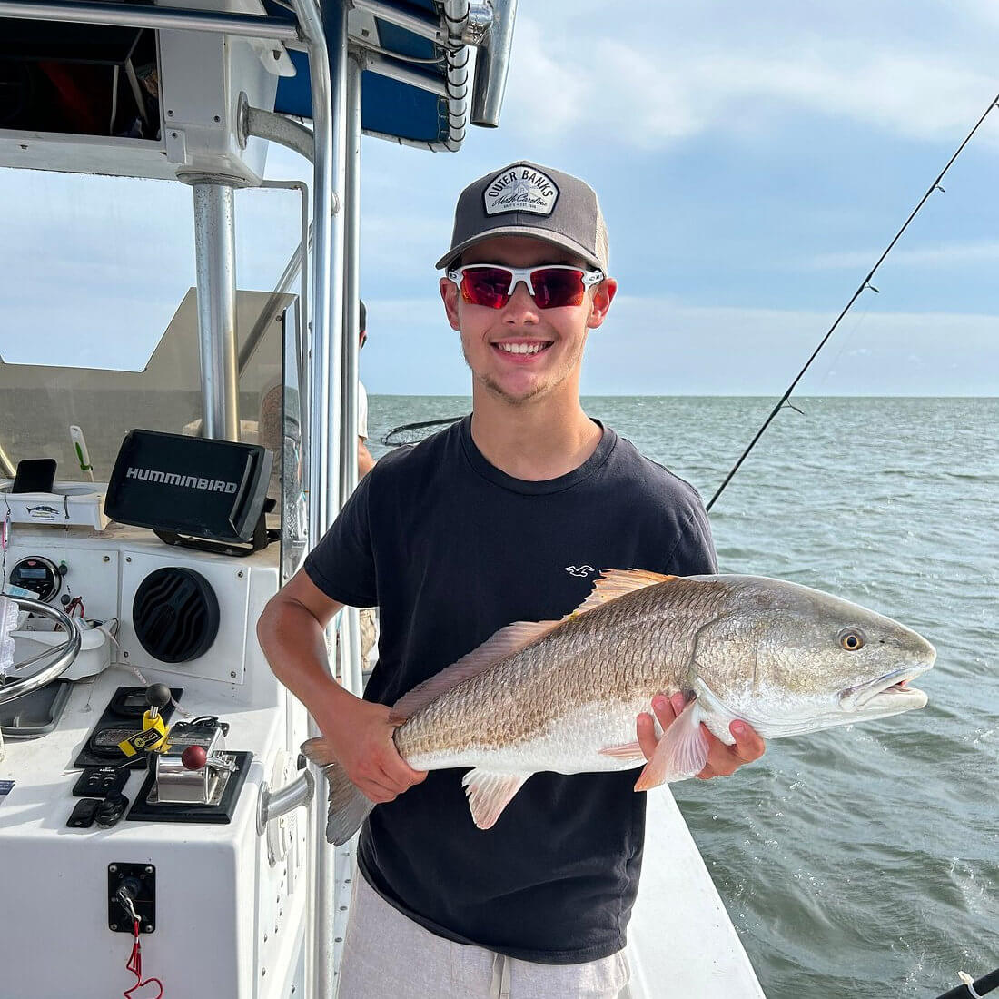 Angler holds up nice red drum.