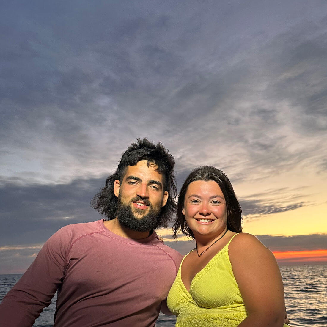 Young couple enjoys sunset cruise.